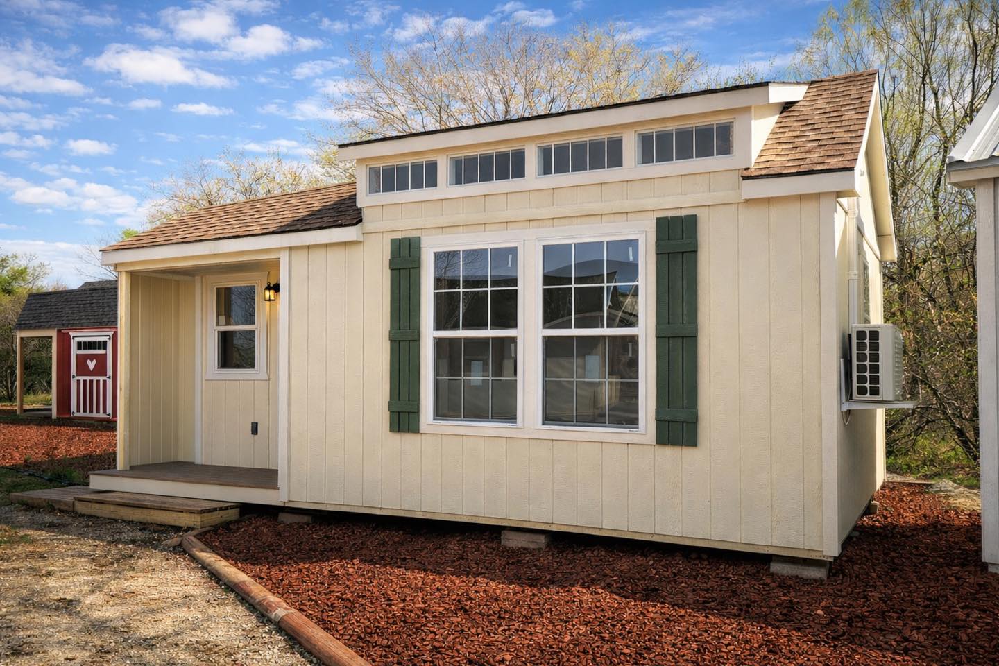 Alamo Series shed with a porch, dormer windows, and exterior shutters