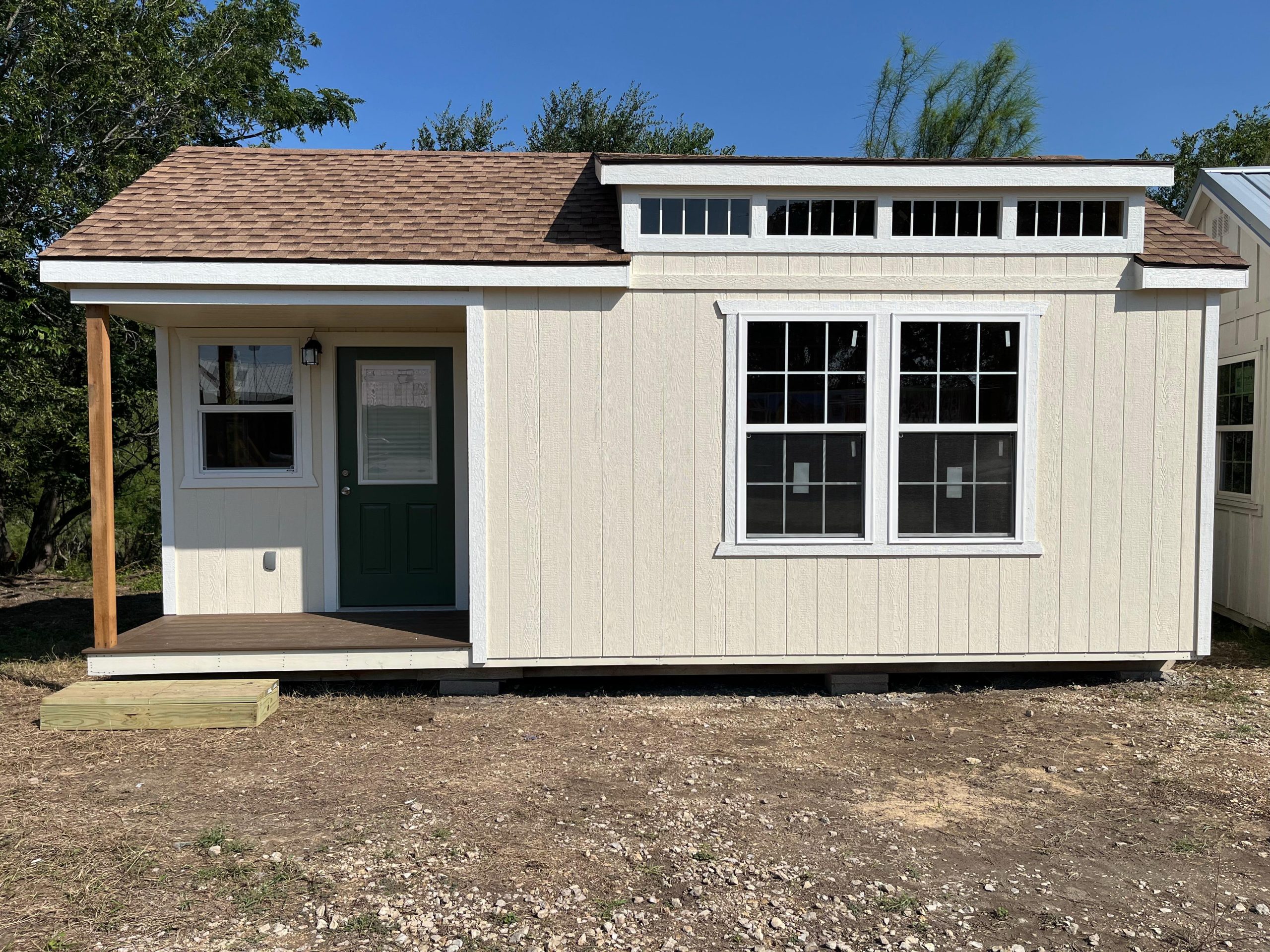 Front view of an Alamo Series shed with a porch and dormer windows