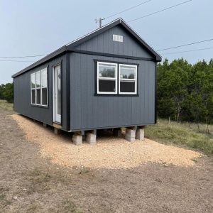 Gray Alamo Series shed showing its A-frame roof, house-style door, and windows