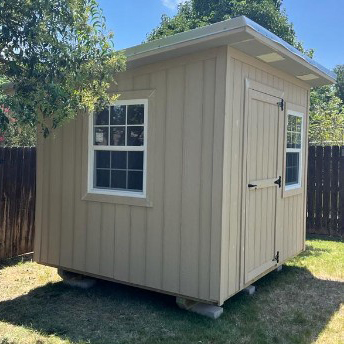 Light-colored Studio Shed with a glazed door and multi-pane window
