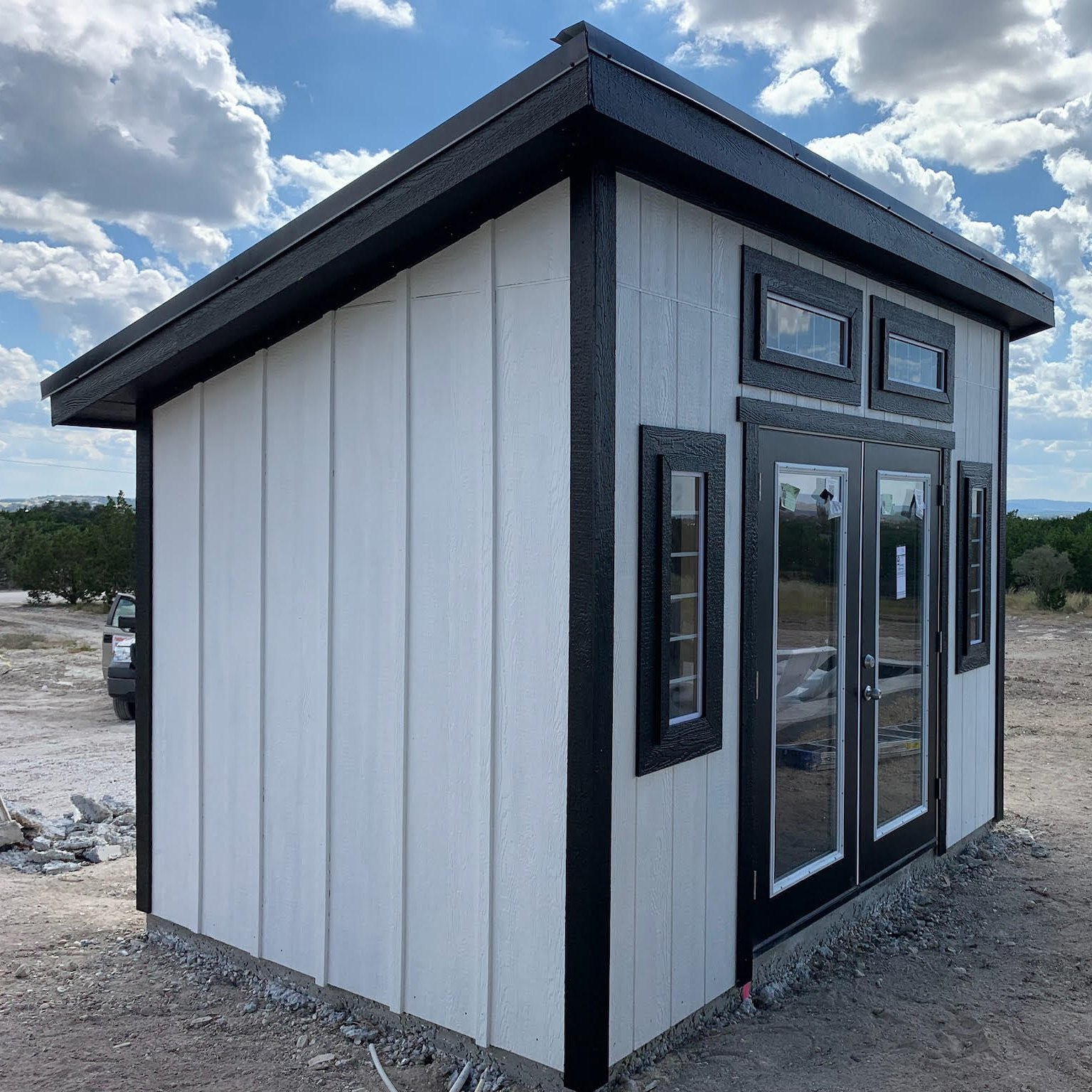Studio Shed exterior showing its sloped roof and tall glass doors